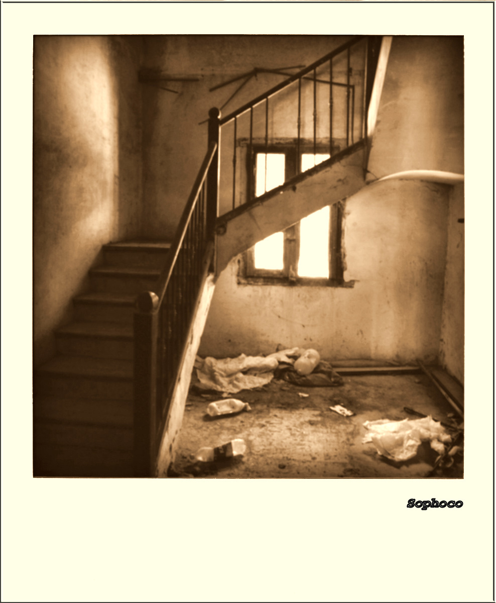 a room with stairs and broken down bags