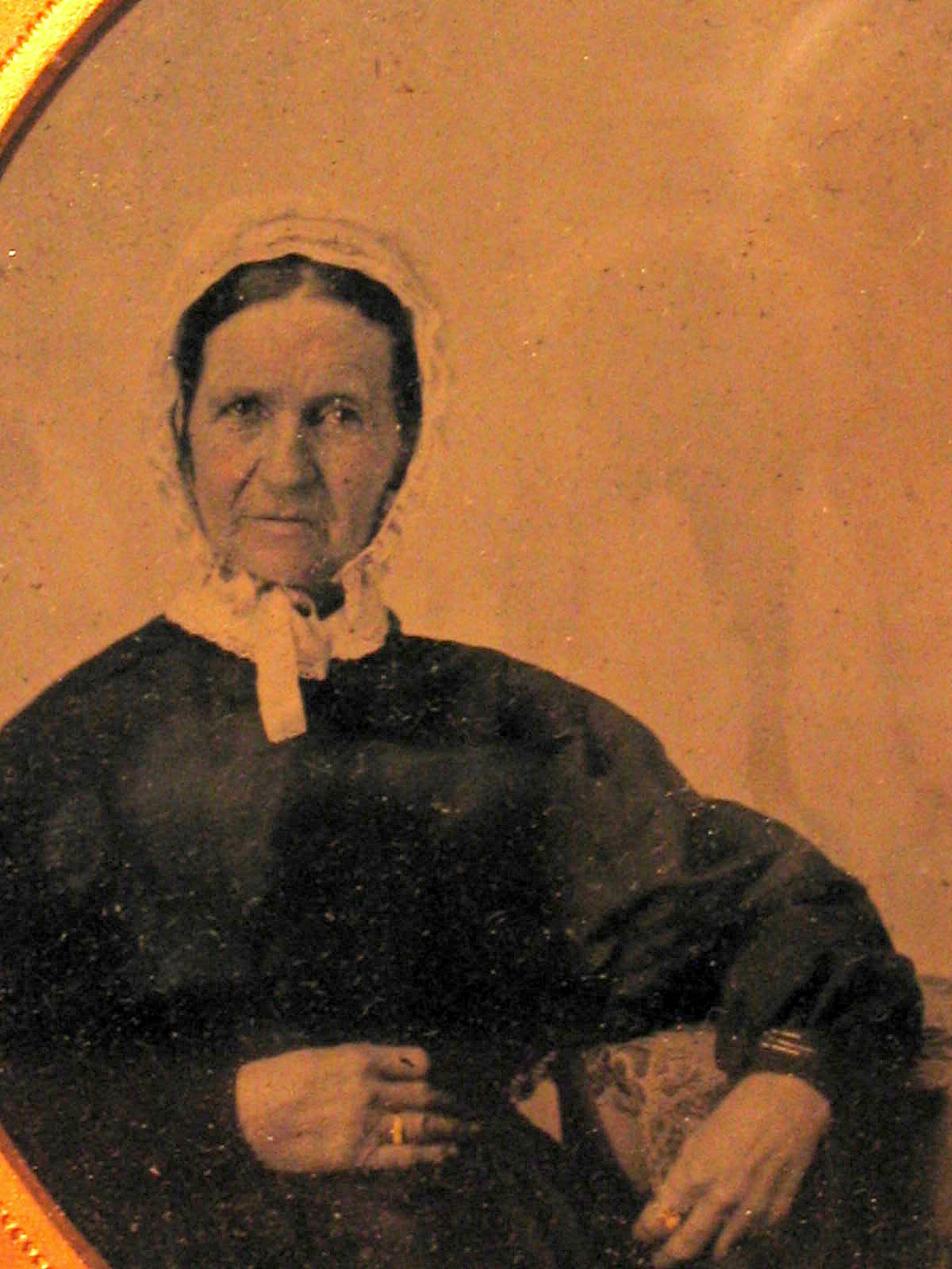 an old time pograph of a woman in black dress