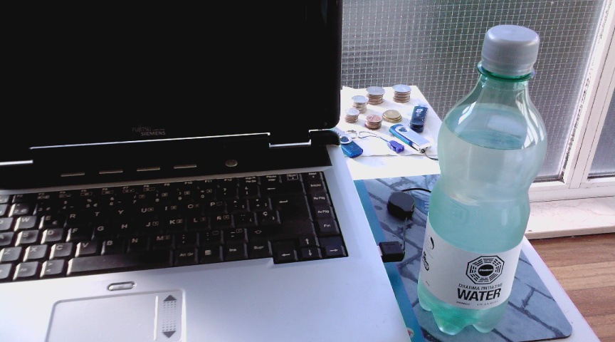 a bottle of water and a laptop computer