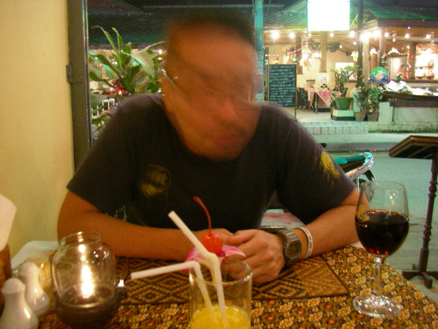 a man is sitting at a table with some drinks