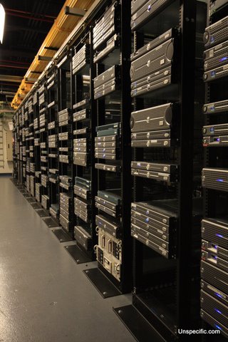 stacks of large and small computer equipment sitting in a room