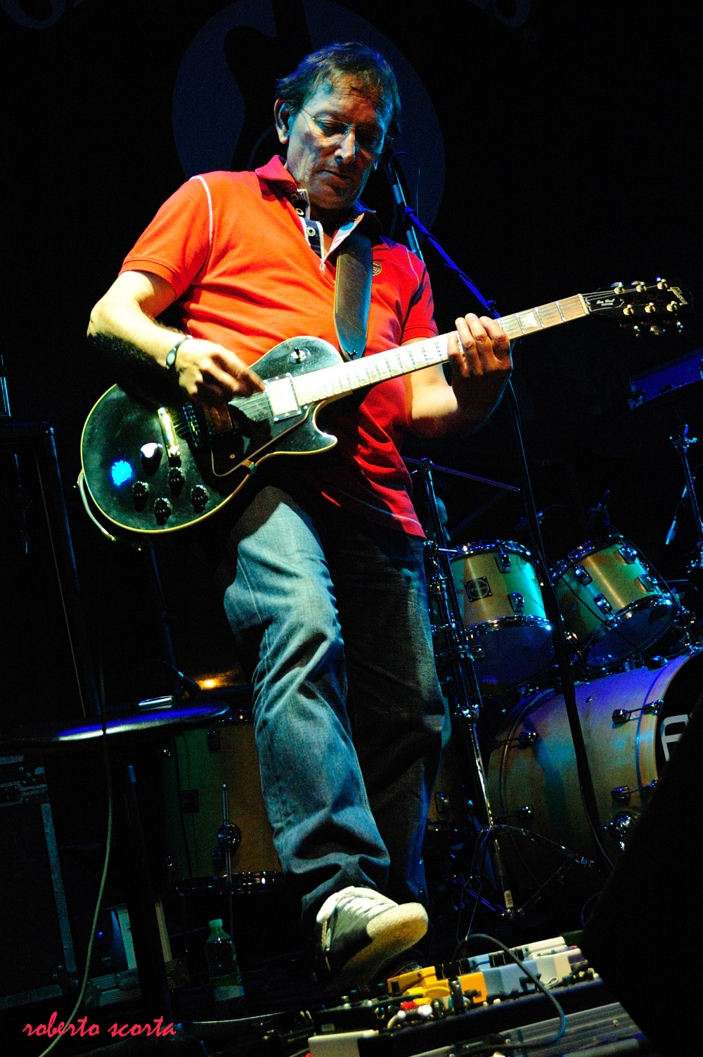 a man playing an electric guitar on stage