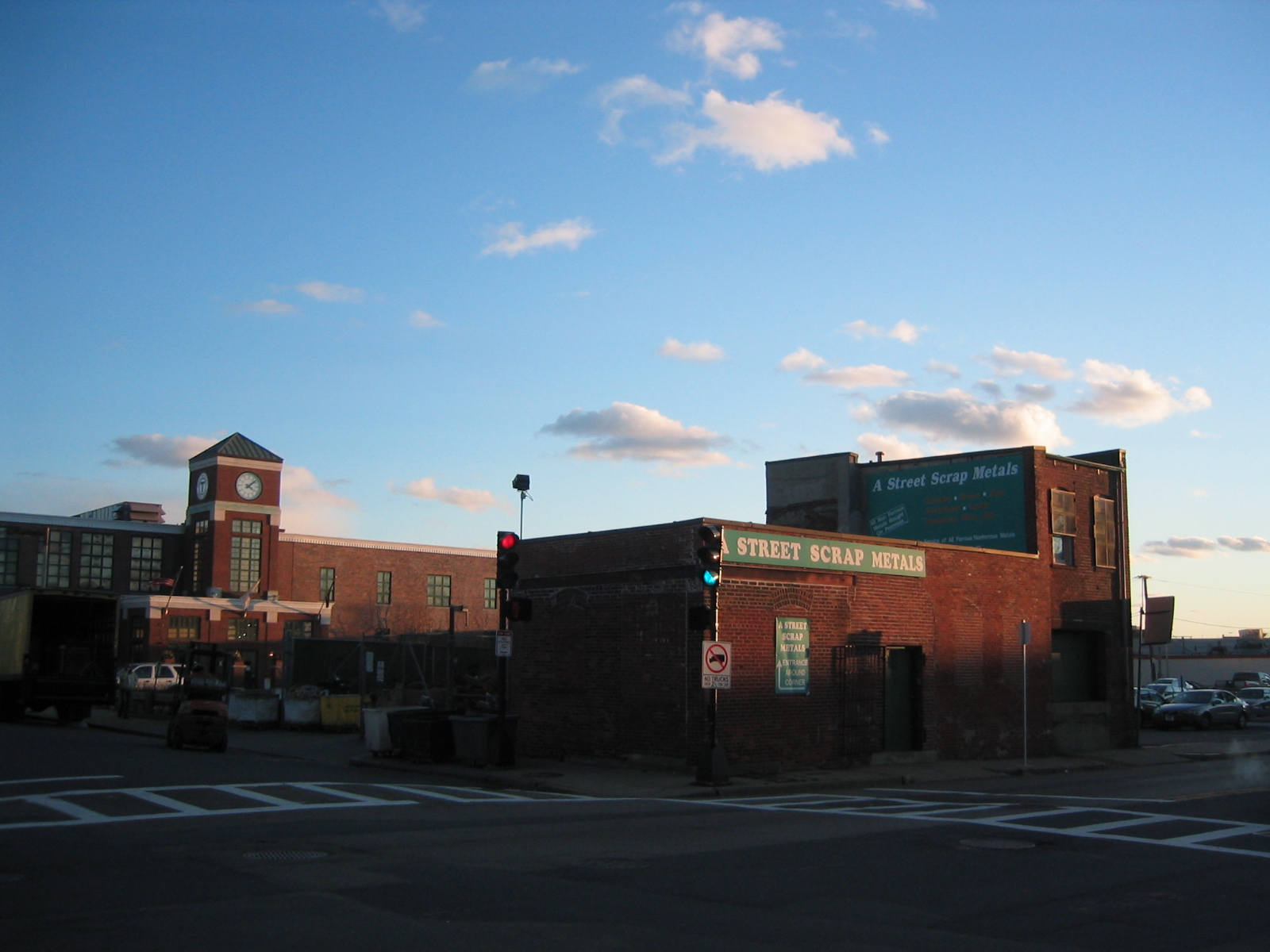 a city street next to brick buildings with a traffic signal at an intersection