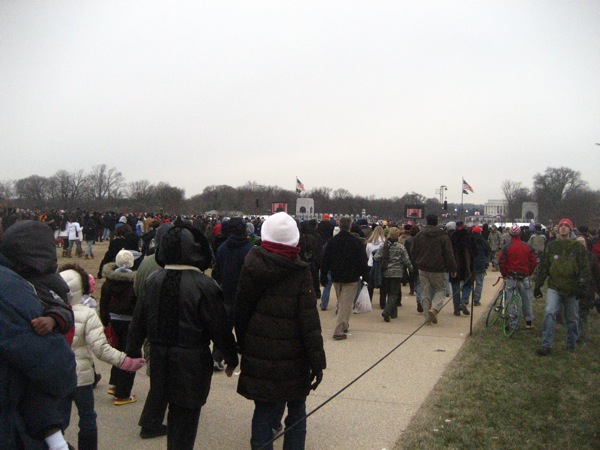 people walking on the sidewalk in a crowd