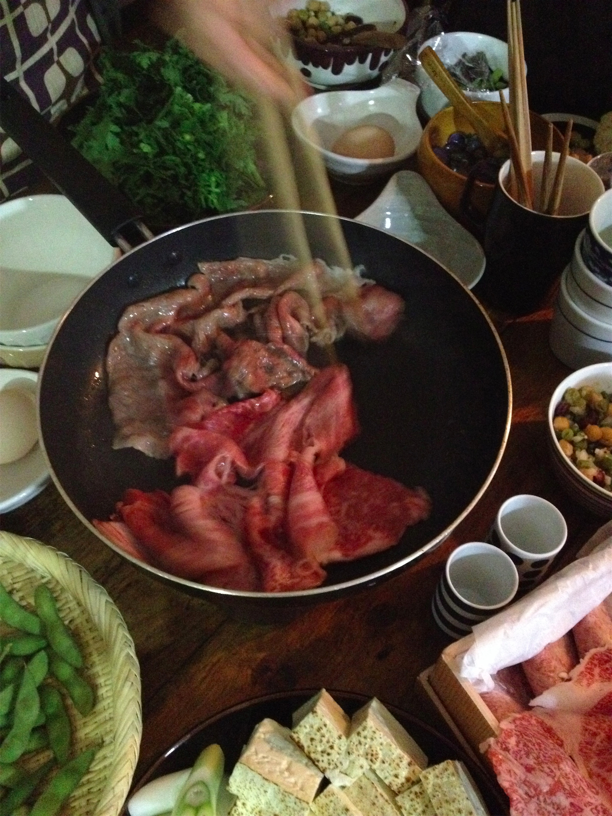 a buffet is topped with meats, vegetables and side dishes