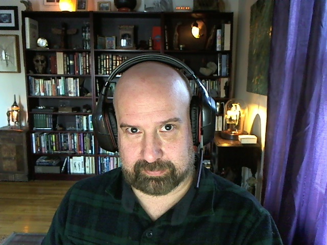 a man wearing headphones and a black shirt