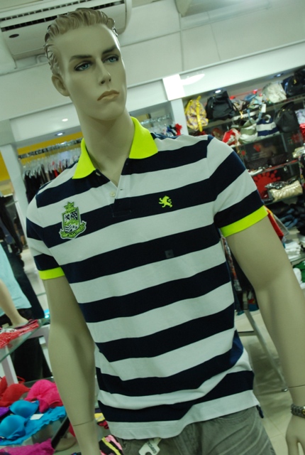 the mannequin is wearing a striped shirt in a store