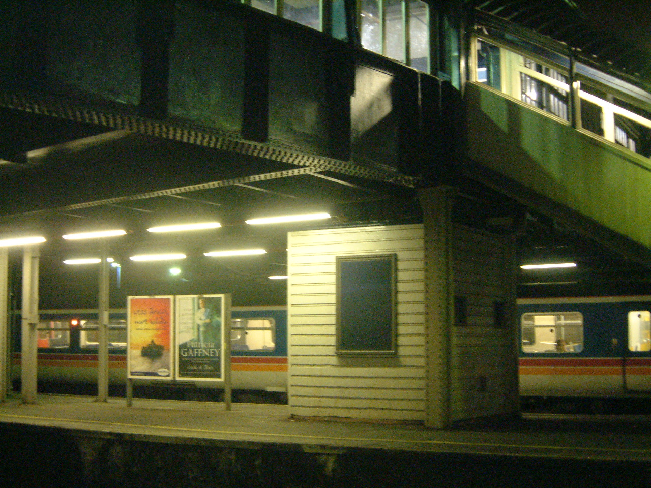 subway train approaching station at night, with subway stop