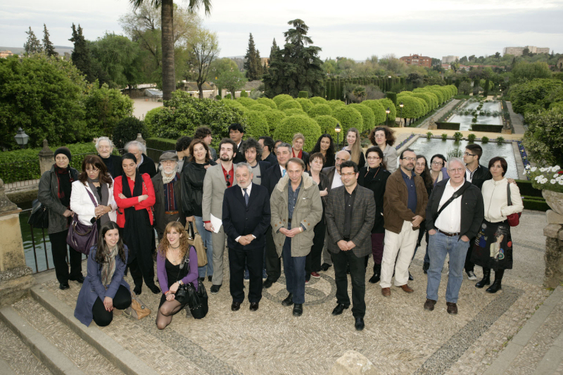 a group of people standing in front of a garden