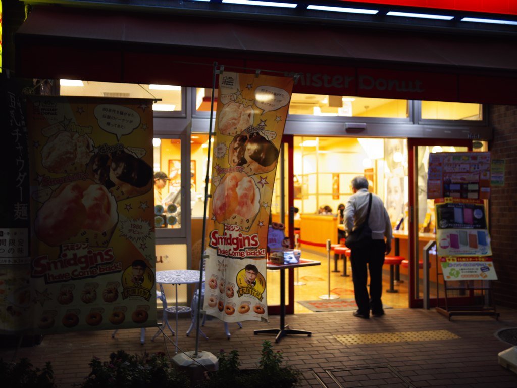 a store with a man entering the entrance