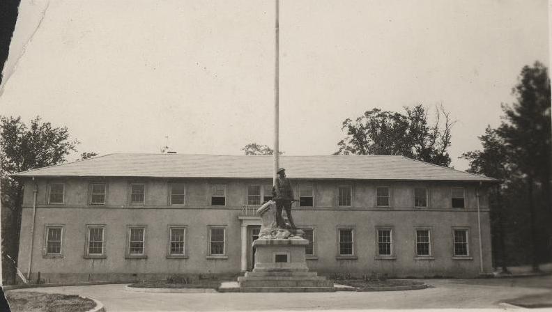 a black and white po with an old building and the flagpole flying