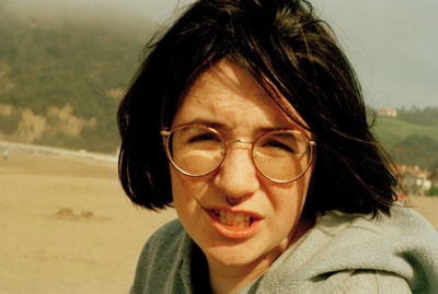 a woman in glasses making a funny face