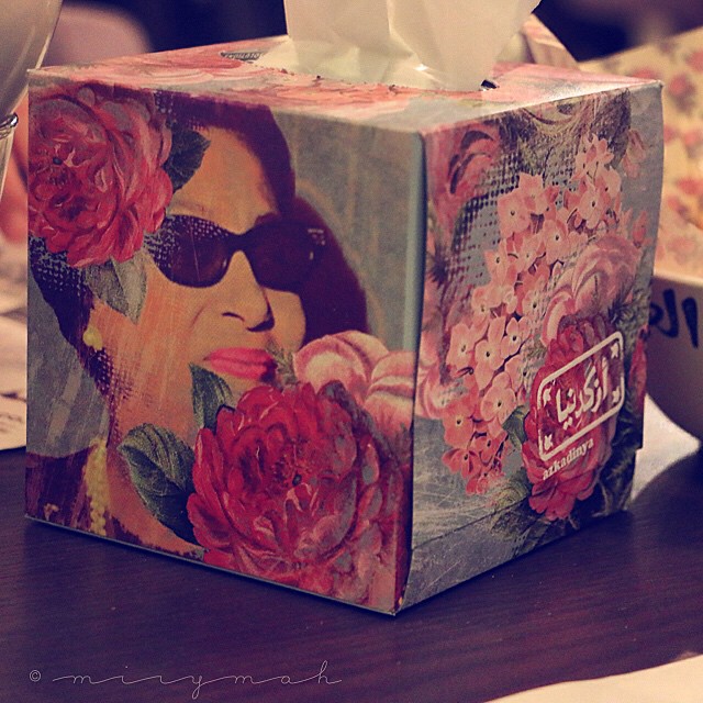 an antique tissue box has a woman and roses on it