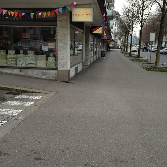 an empty road with lots of decorations outside of the store
