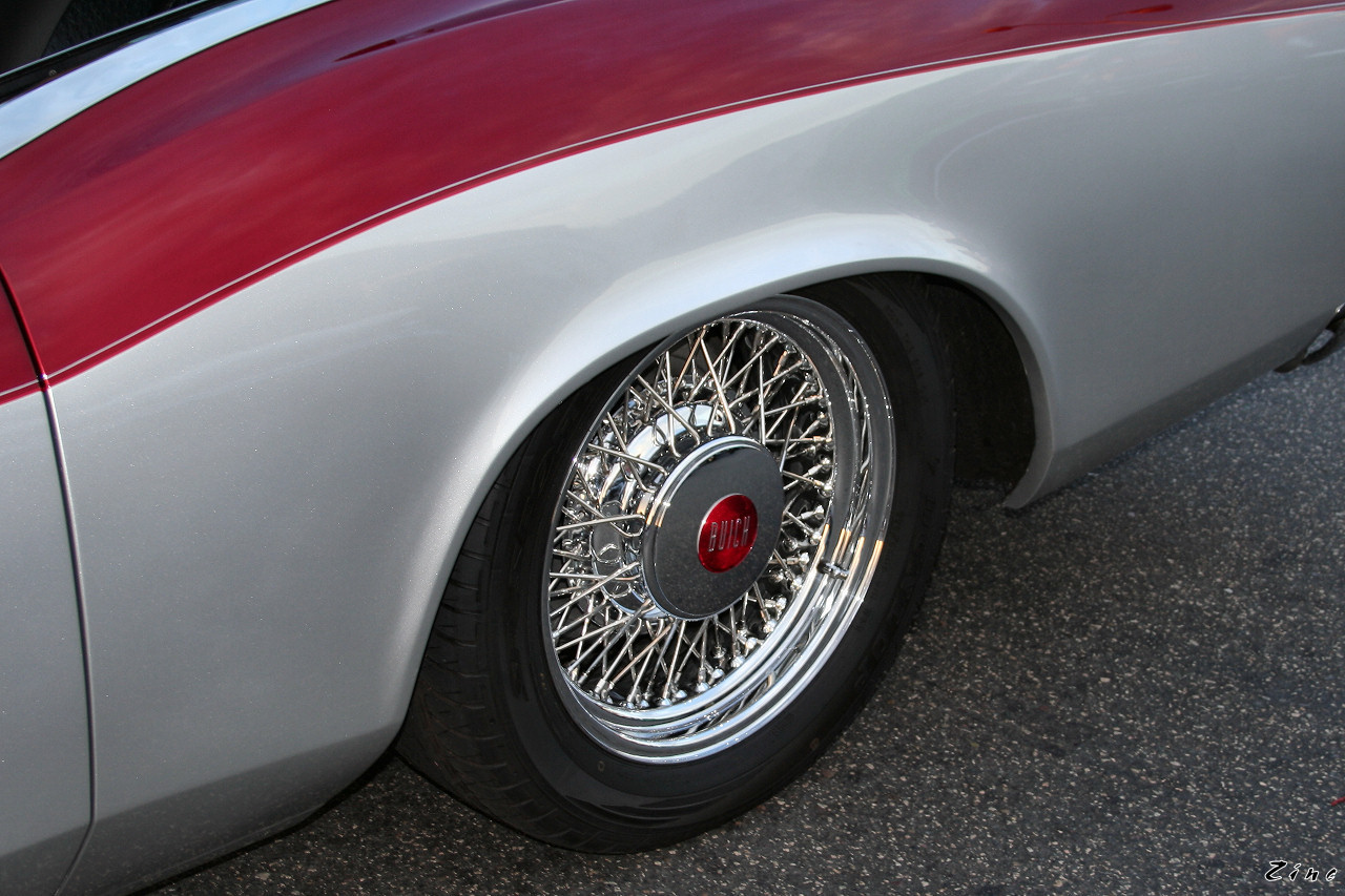 a closeup of the chrome wheels of an old car