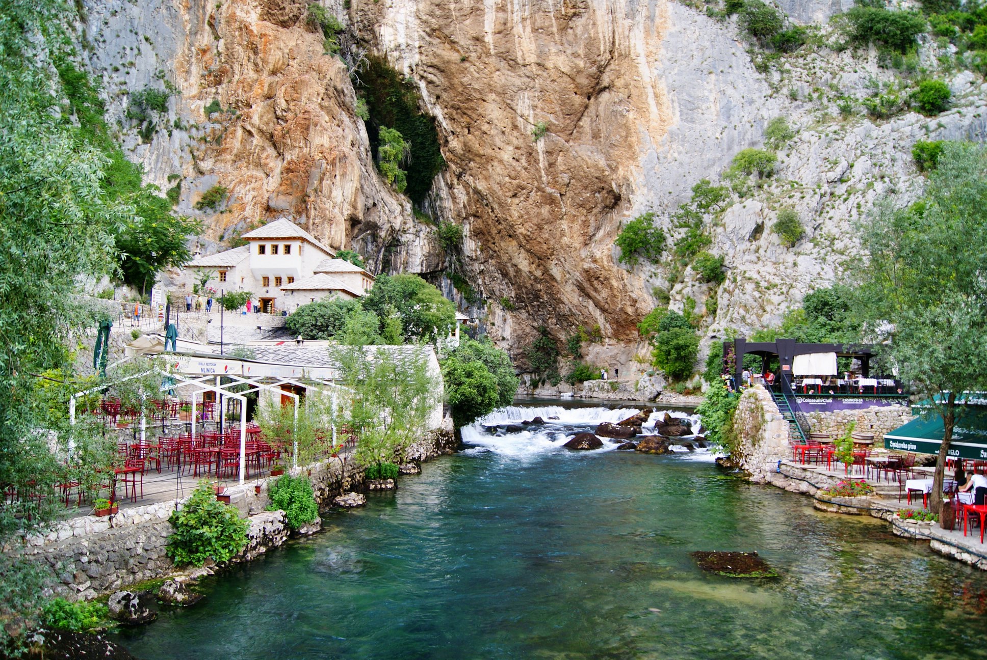 a river runs between two mountains with houses in the center