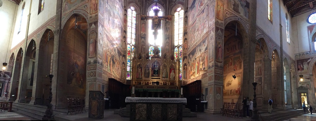 a cathedral with two rows of pews and some tables