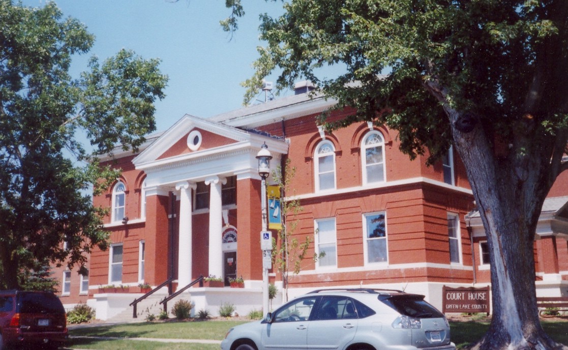 a car parked in front of a building with columns