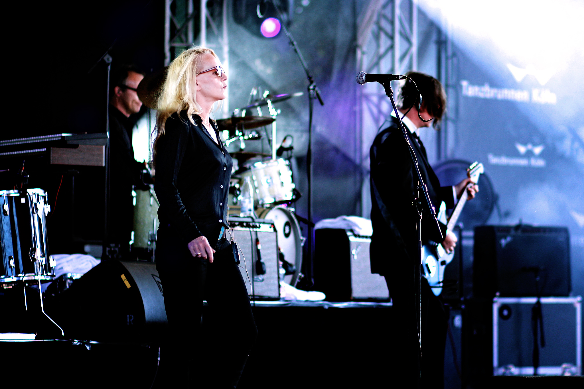 two women on stage with some guitars and microphones