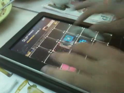 someone using their tablet to play the game