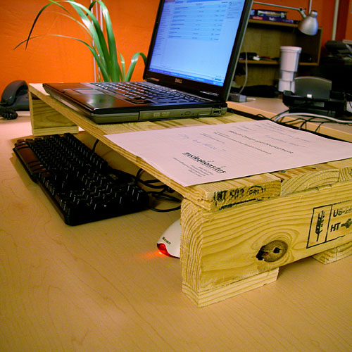 an opened laptop on top of a wooden box