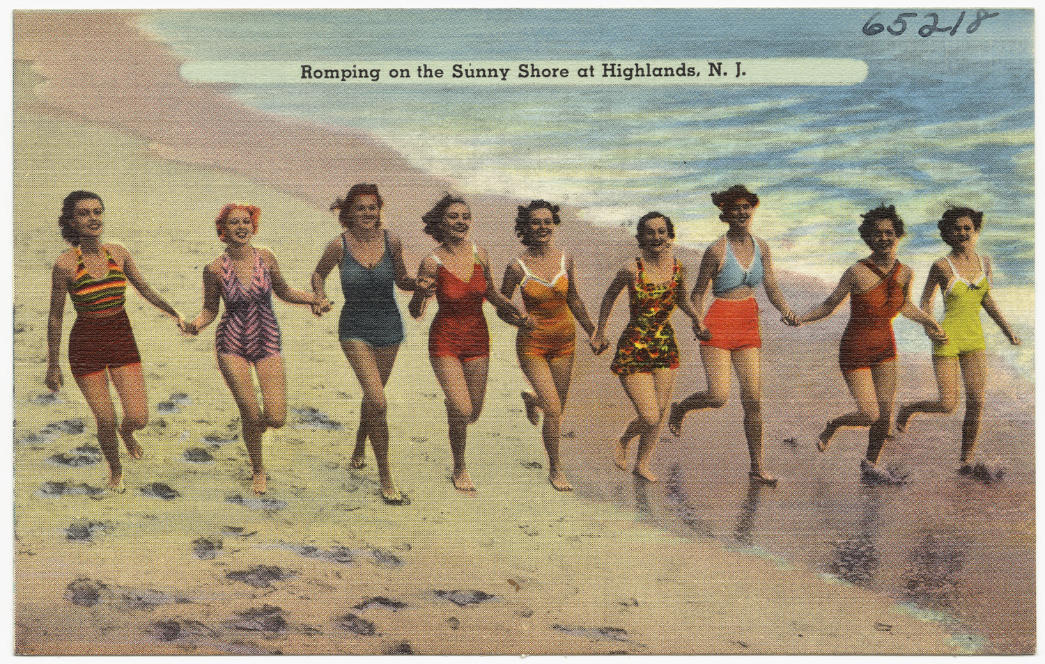 women on beach in swimsuits walking toward the water