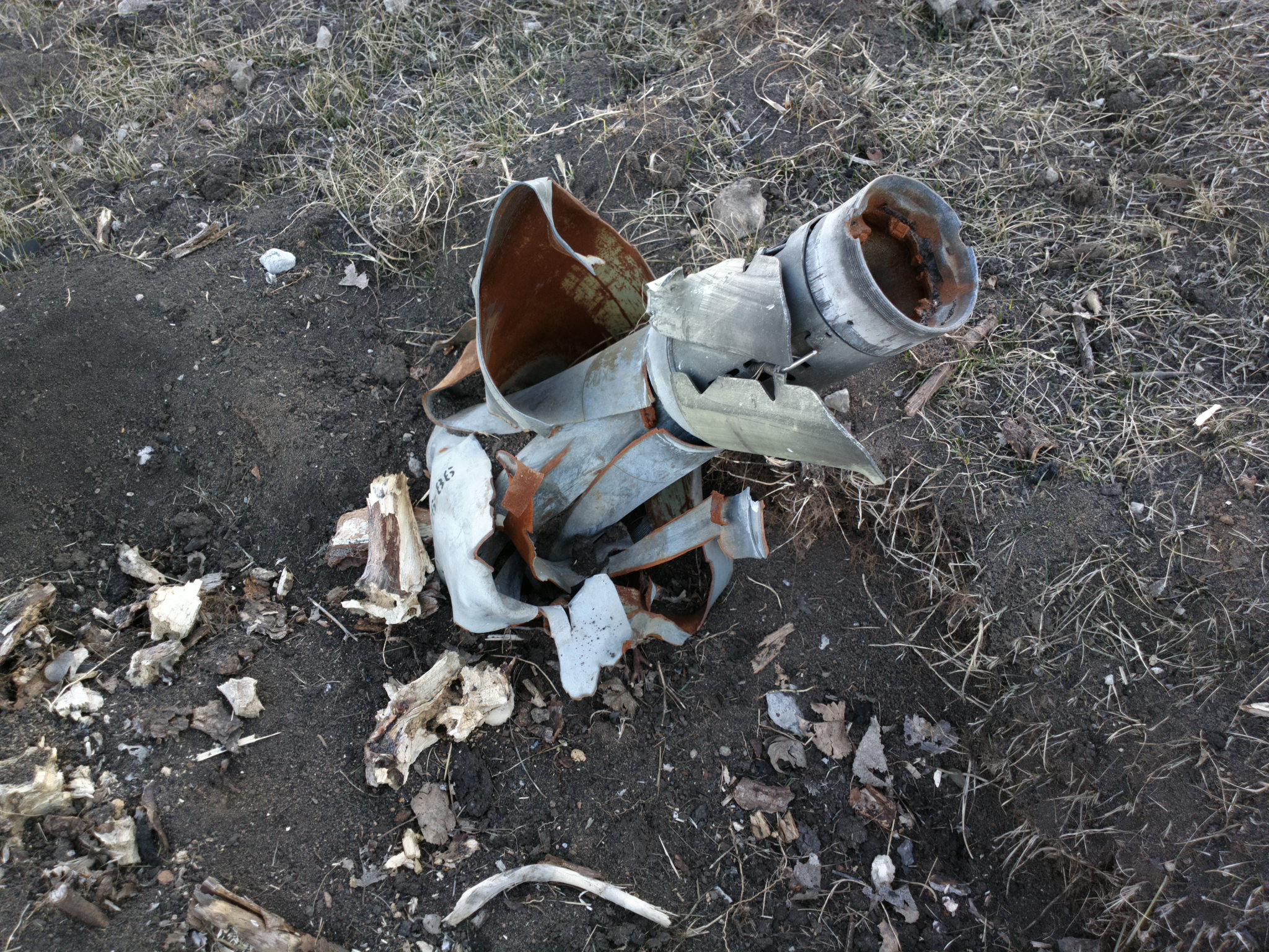 an old metal fire hydrant sitting on top of a field