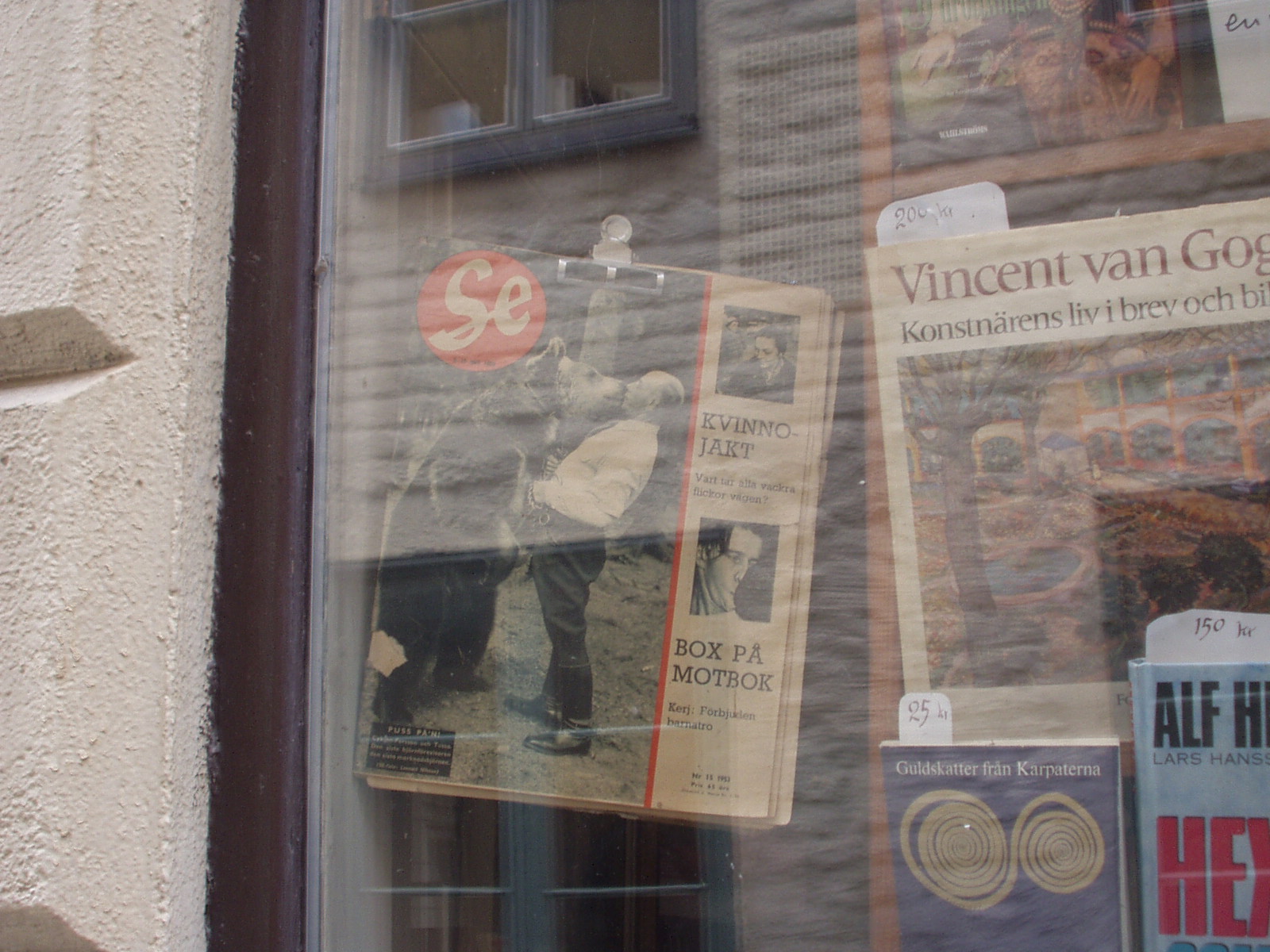 a newspaper hangs on a window of a store