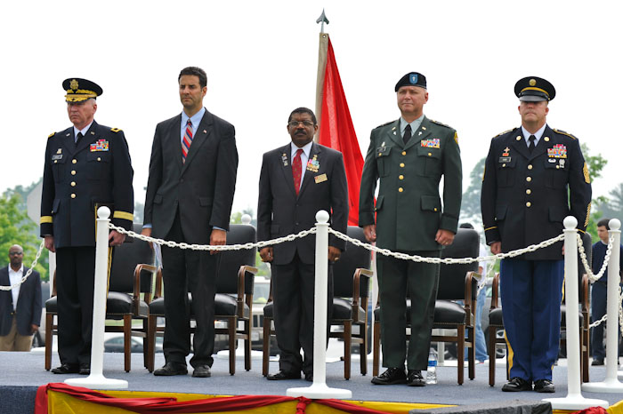 a group of men standing around with flags in the background