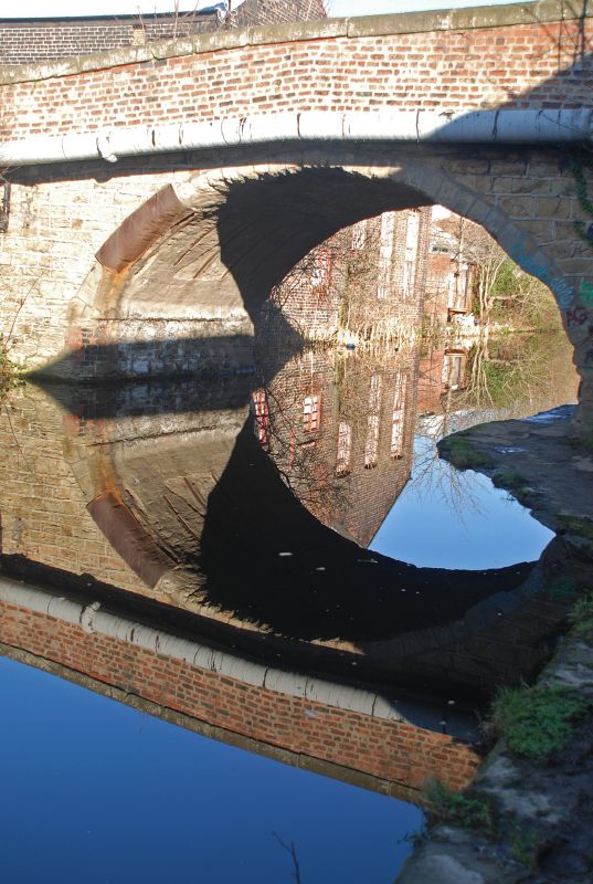 an empty bridge with reflection of itself in the water