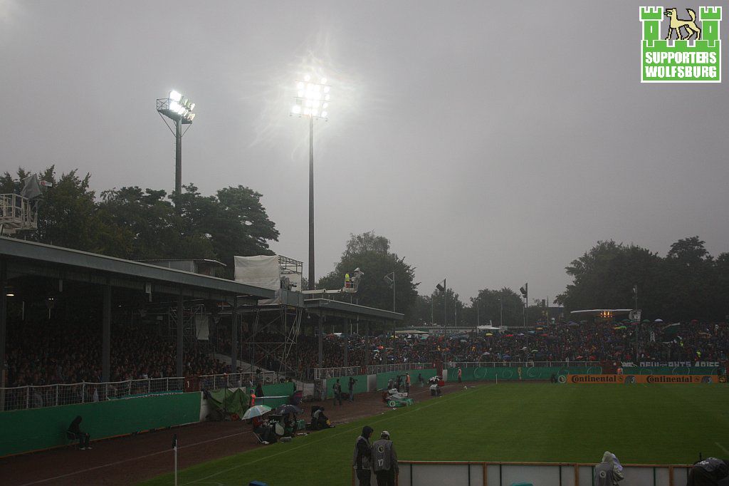 many people are playing on a field in the rain