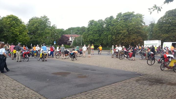 a large group of people gathered together on bikes