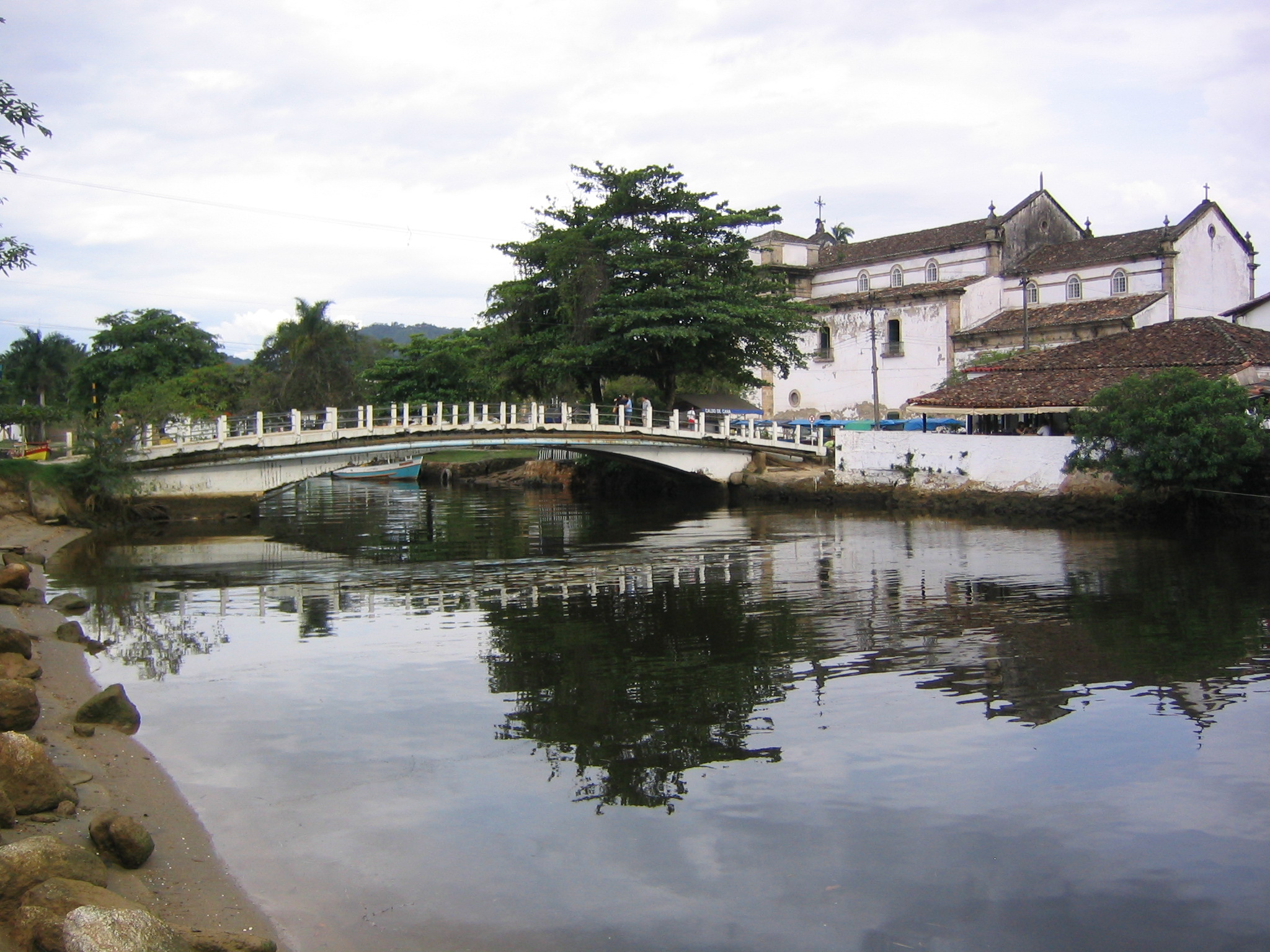a bridge crossing over a calm river in the city