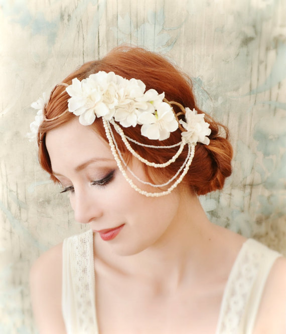 a woman is wearing a floral hair comb