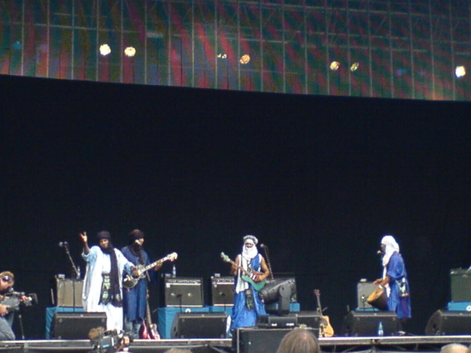a group of people on stage with guitars