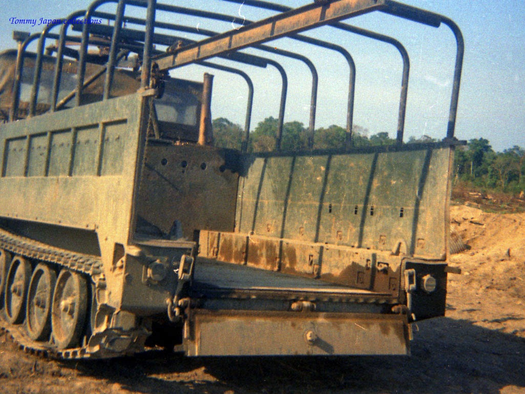 a military vehicle with multiple mirrors and bars on the back