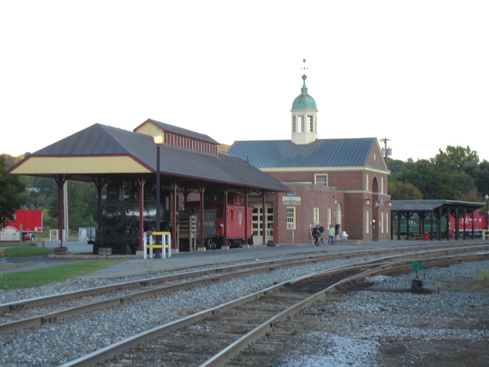 a train station with people waiting for a train