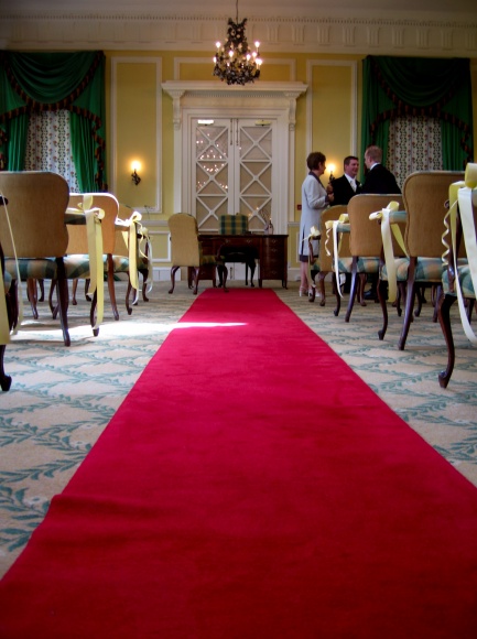 a red carpet sits between chairs in a room