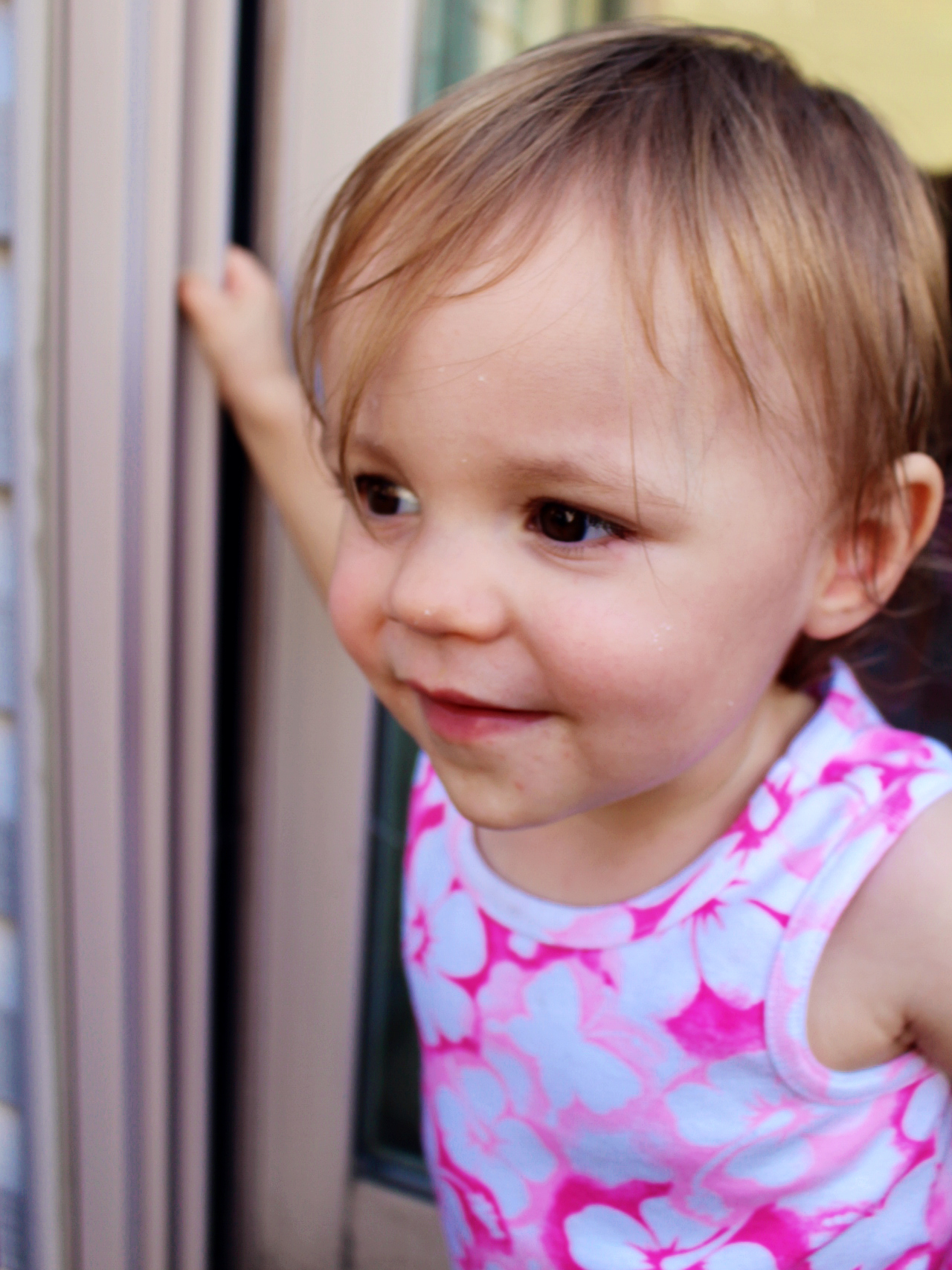 a young child with pink and white shirt on staring at camera