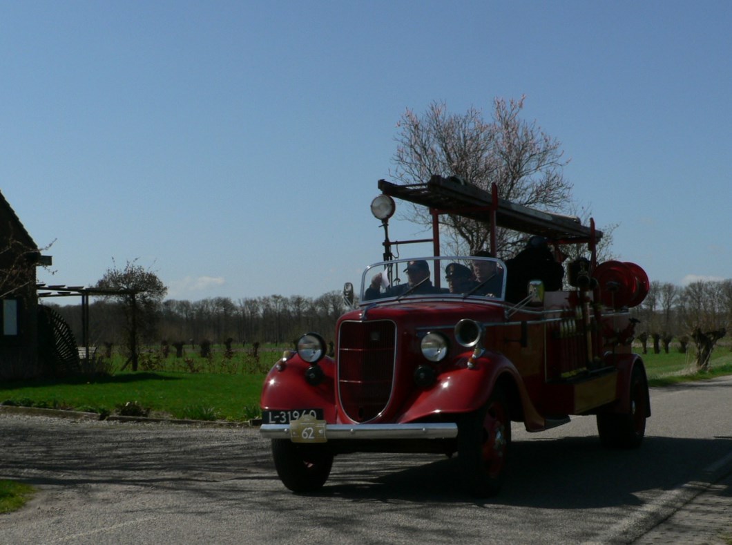 an old fashioned fire engine is on a street