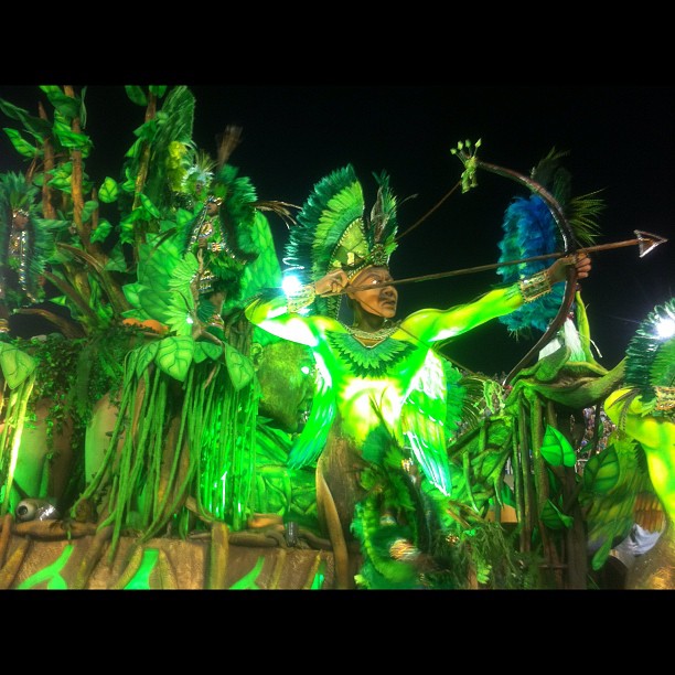 an artistic dance at a carnival with people dressed in green