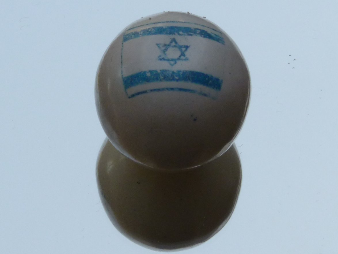 three white and blue balls with the flag of the country israel on one