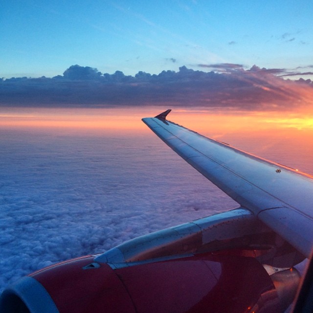 a view from the inside of an airplane at sunrise or sunset