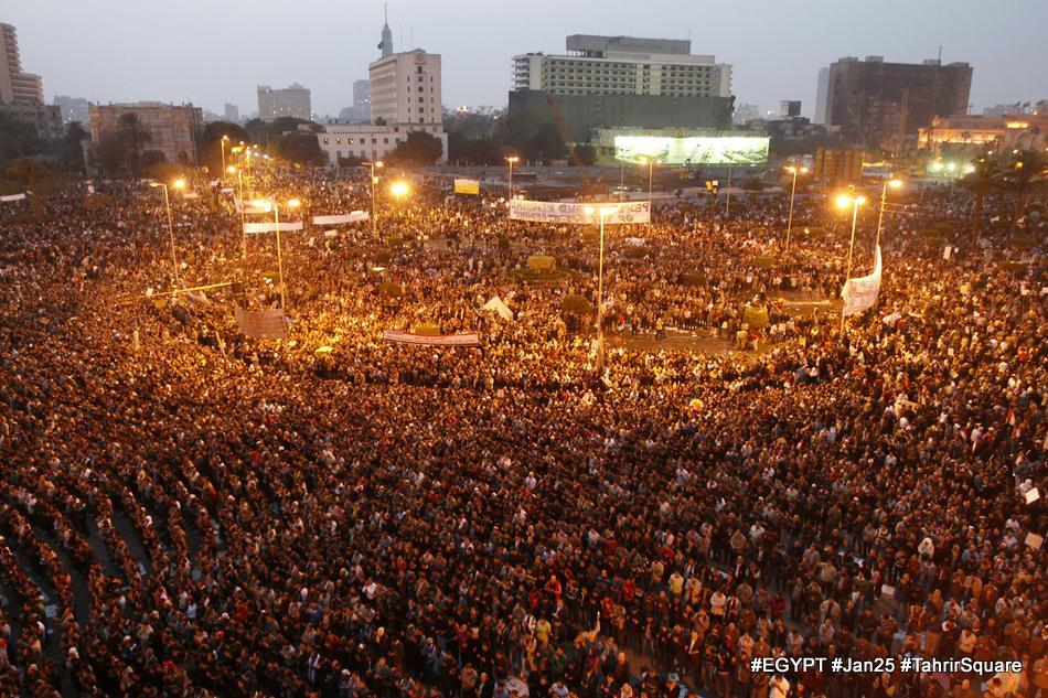 a large crowd at a rally with flags