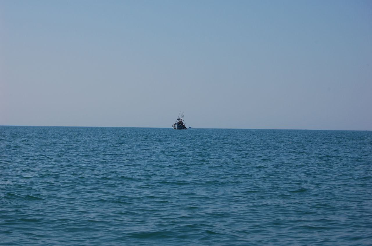 a sailboat sailing in the open sea