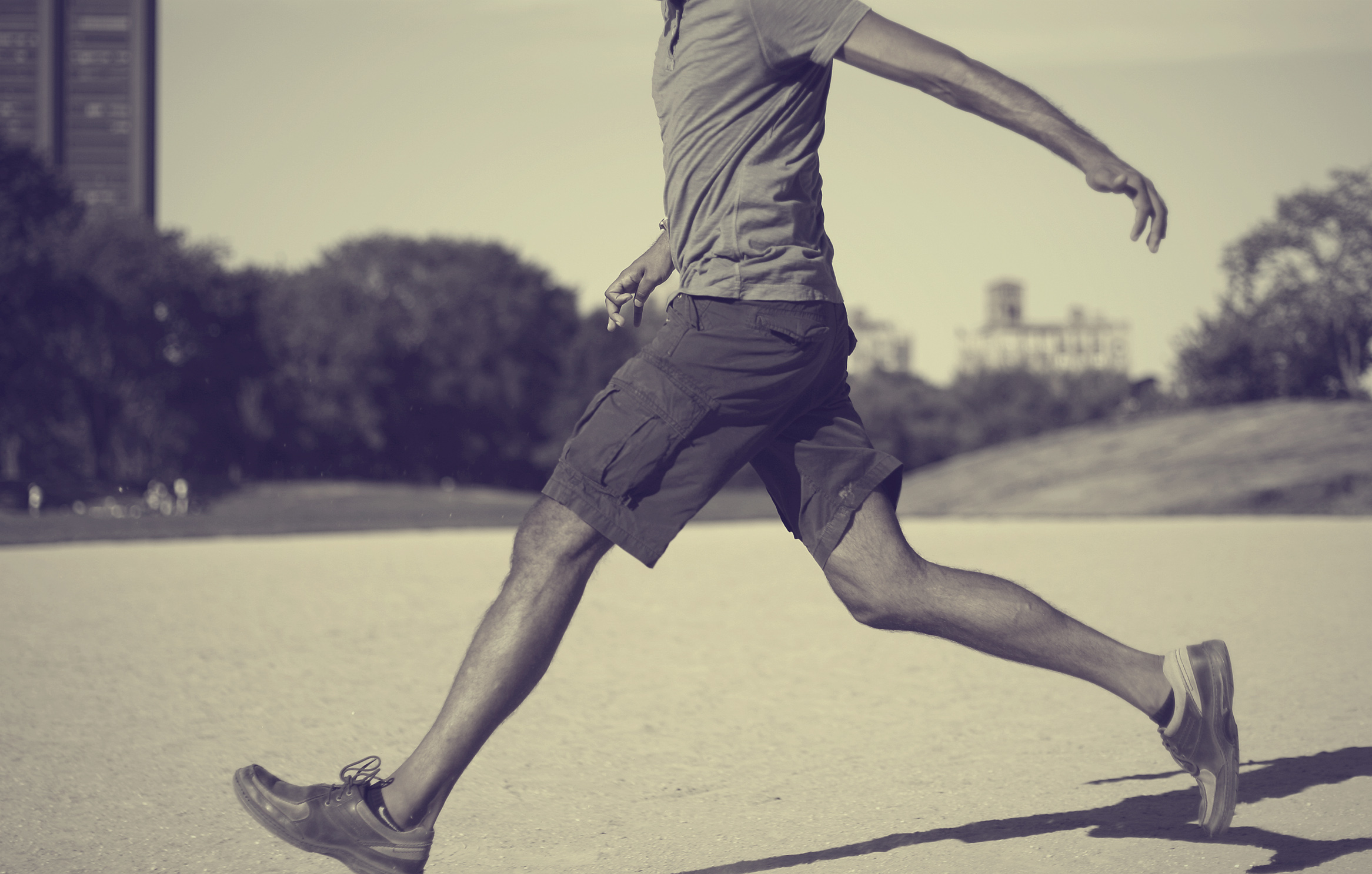 a man running with his foot on a skateboard