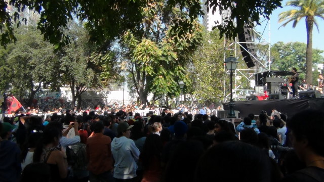 a crowd is standing outside during a stage