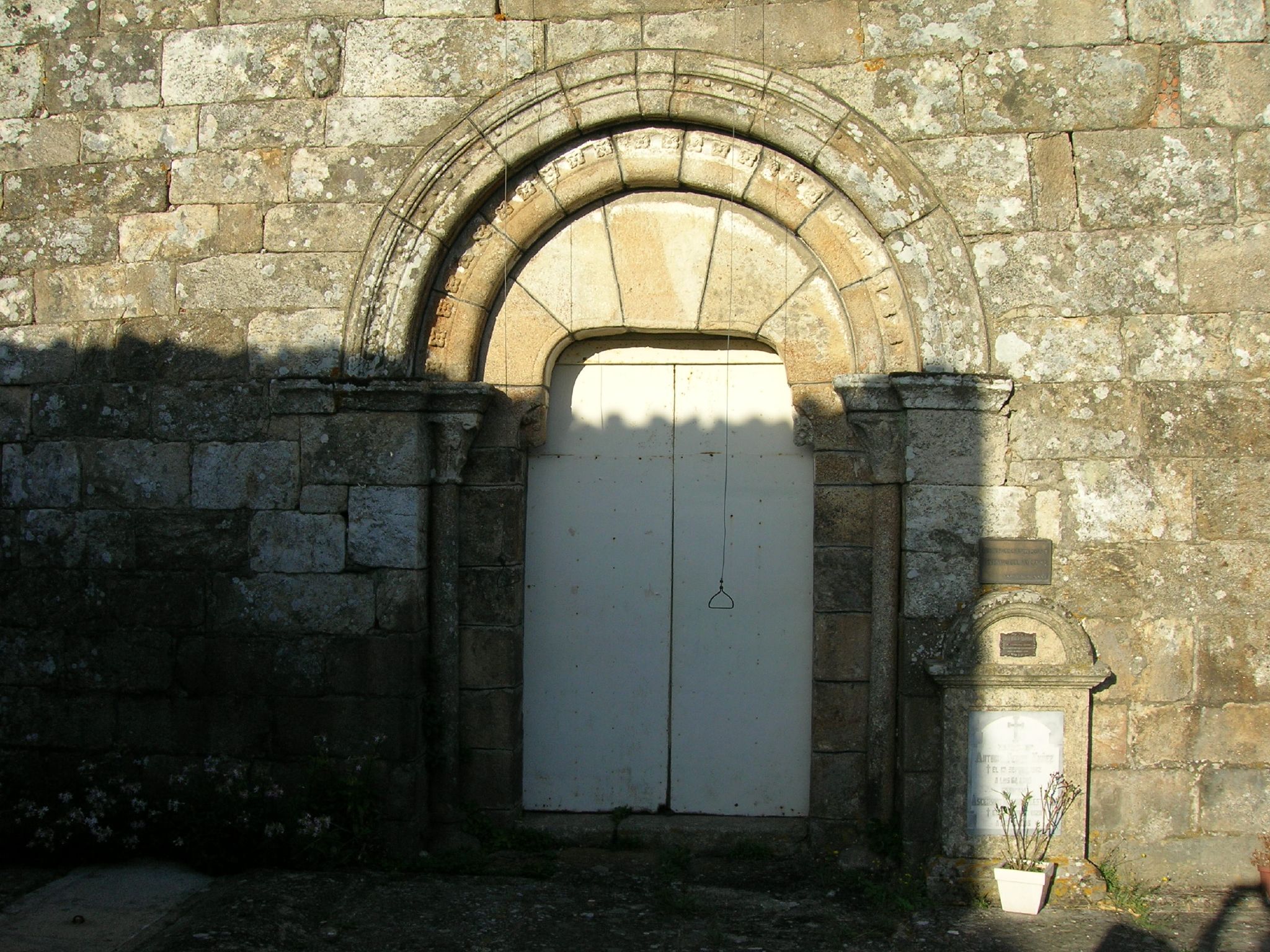 the doorway is next to the side of a large building