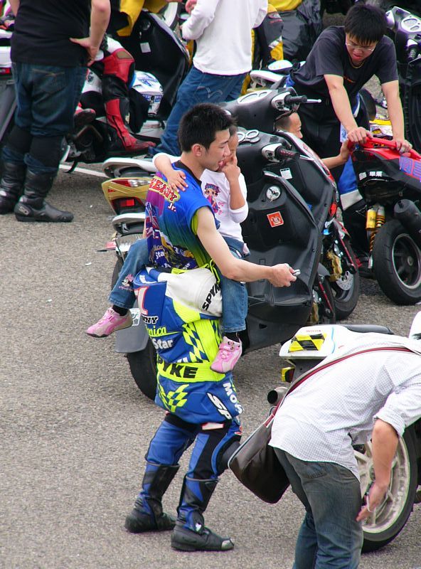 a man standing next to two men in a group