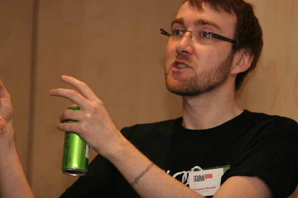 a man is holding a soda can and pointing it at soing